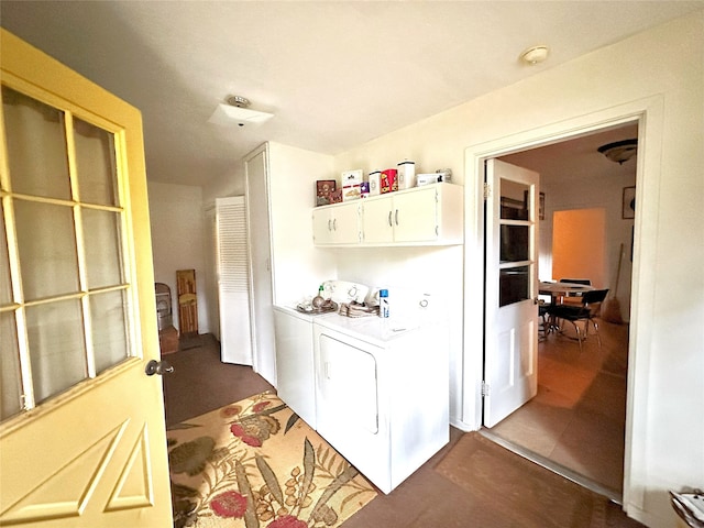 laundry area featuring independent washer and dryer and cabinets