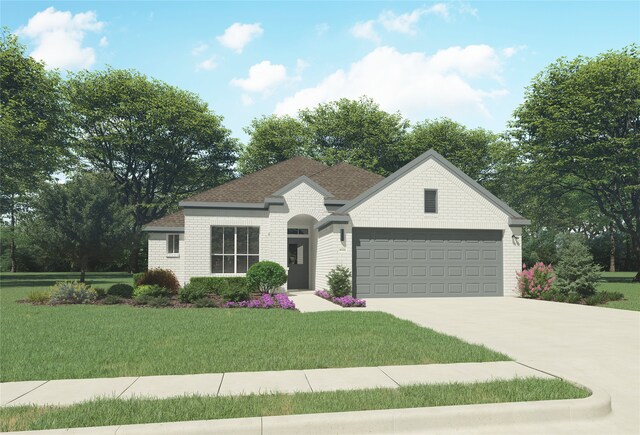 view of front of home with a front yard and a garage