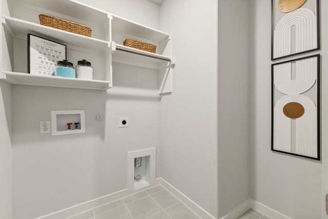 washroom with electric dryer hookup, hookup for a gas dryer, light tile patterned floors, and hookup for a washing machine