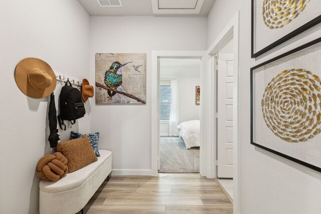 hallway with light hardwood / wood-style flooring