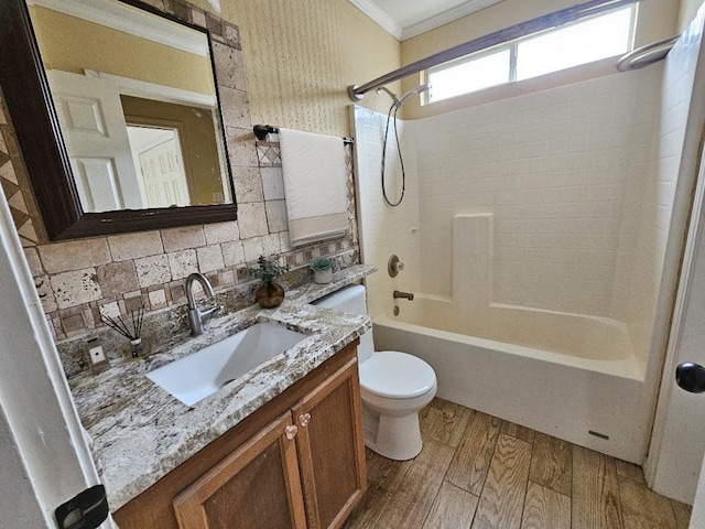 full bathroom with tasteful backsplash,  shower combination, vanity, crown molding, and hardwood / wood-style flooring