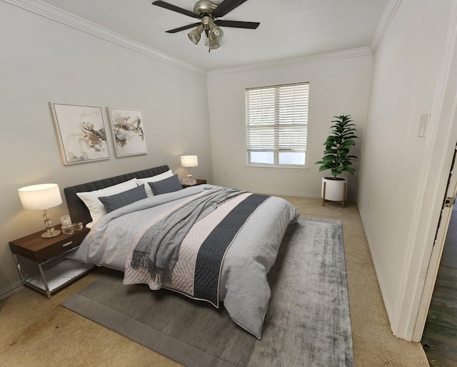 carpeted bedroom featuring ceiling fan and ornamental molding