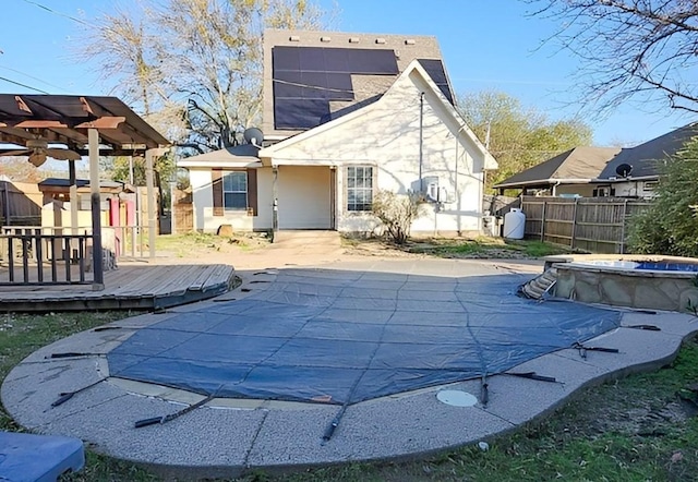 back of property featuring a pool side deck