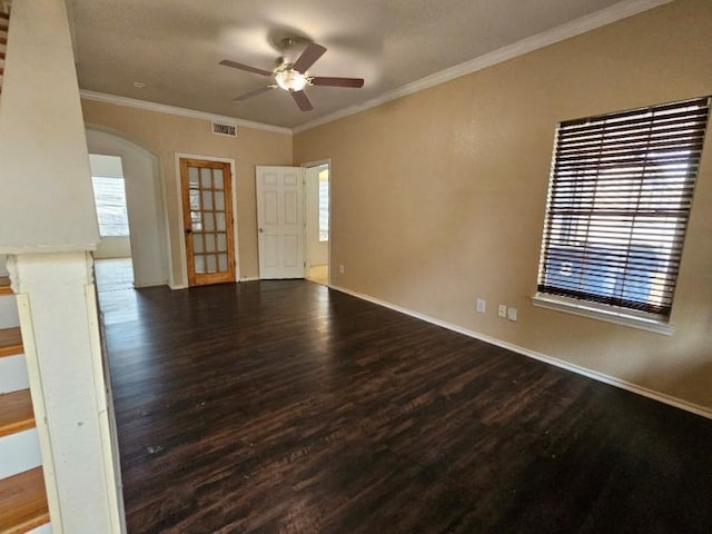 unfurnished room featuring a wealth of natural light, dark hardwood / wood-style flooring, and ornamental molding