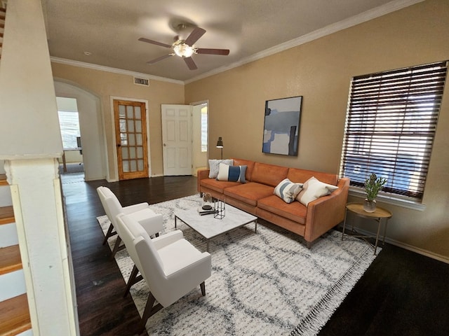 living room with a wealth of natural light, hardwood / wood-style floors, ceiling fan, and ornamental molding