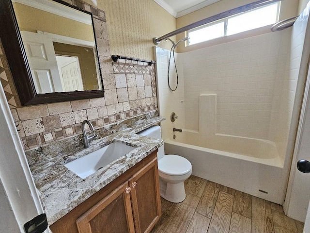 full bathroom featuring vanity, shower / washtub combination, crown molding, decorative backsplash, and wood-type flooring