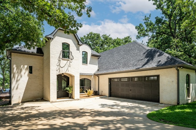 french country inspired facade with a garage