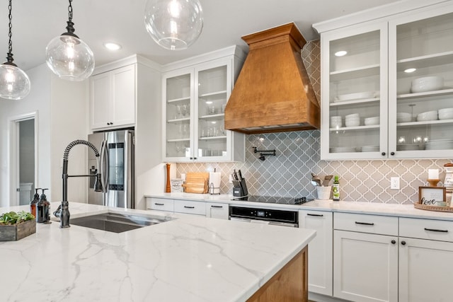 kitchen featuring white cabinets, sink, hanging light fixtures, wall oven, and custom range hood