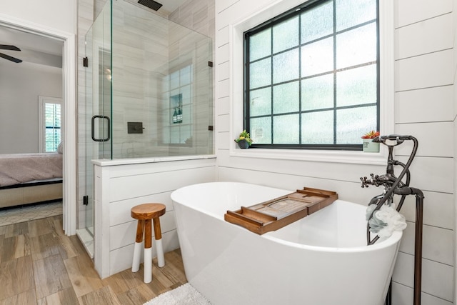 bathroom featuring hardwood / wood-style floors, ceiling fan, and independent shower and bath