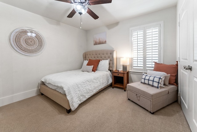 bedroom with ceiling fan and light colored carpet