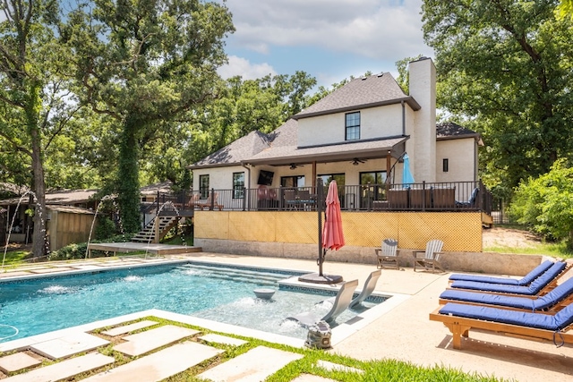 back of house with a swimming pool side deck, ceiling fan, and a patio area