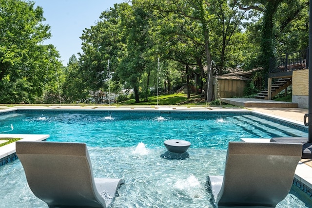 view of swimming pool with pool water feature