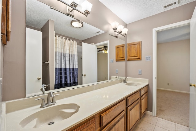 bathroom with vanity, a textured ceiling, tile patterned floors, and ceiling fan