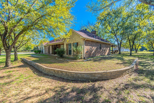 view of side of property with a lawn