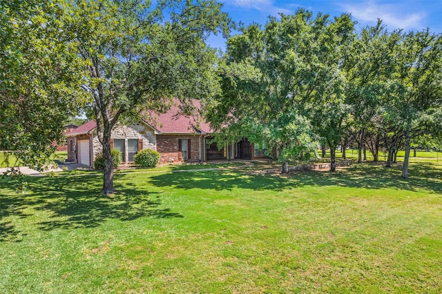 view of front of house featuring a garage and a front yard