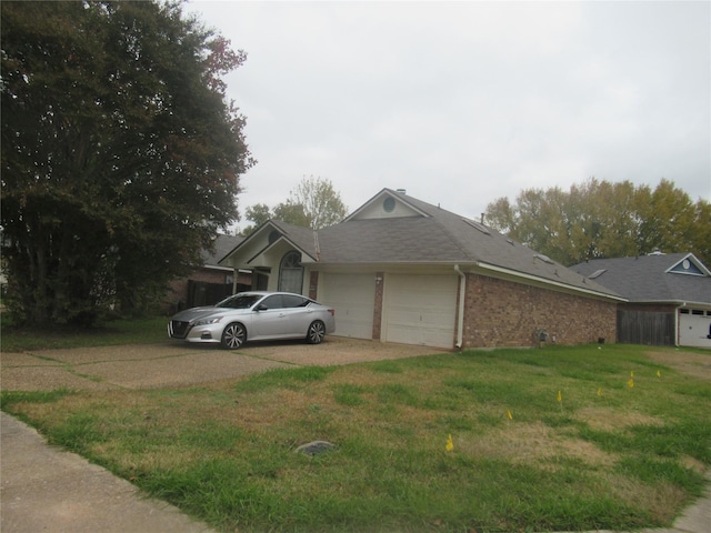 ranch-style house featuring a garage and a front yard