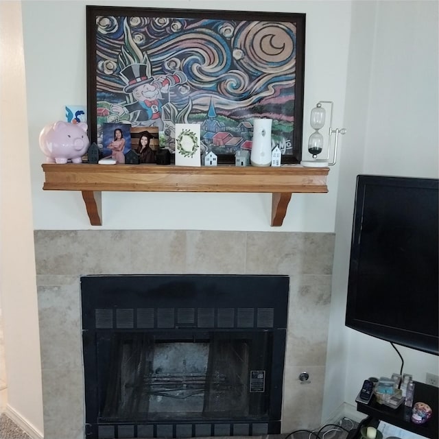 room details featuring a tile fireplace