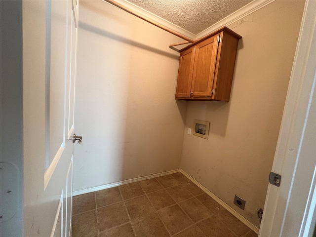 laundry area featuring electric dryer hookup, hookup for a washing machine, cabinets, and a textured ceiling