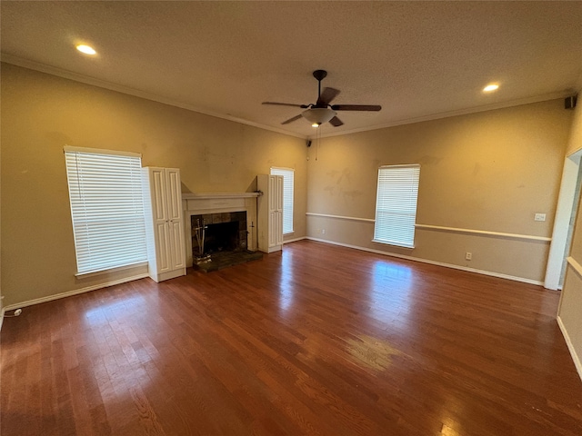 unfurnished living room with ceiling fan, a fireplace, dark hardwood / wood-style floors, and ornamental molding