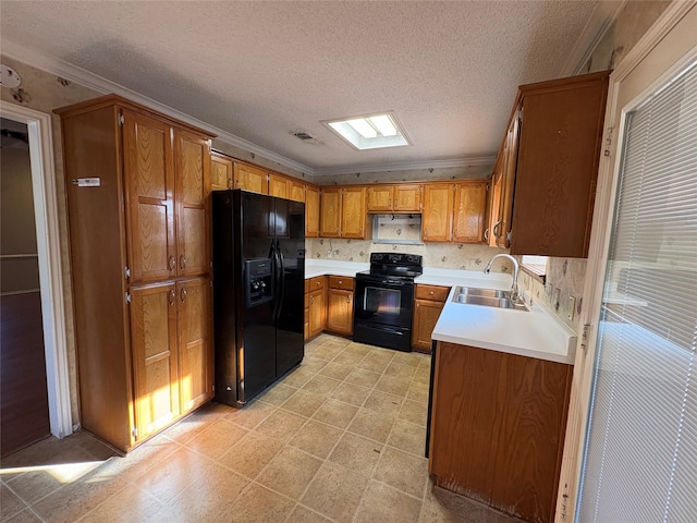 kitchen featuring sink, ornamental molding, black appliances, and a textured ceiling