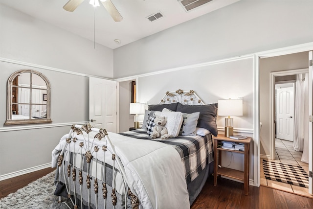 bedroom with dark hardwood / wood-style flooring and ceiling fan