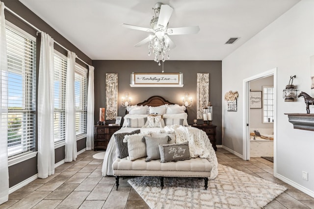 bedroom with ensuite bath, ceiling fan, and light tile patterned flooring