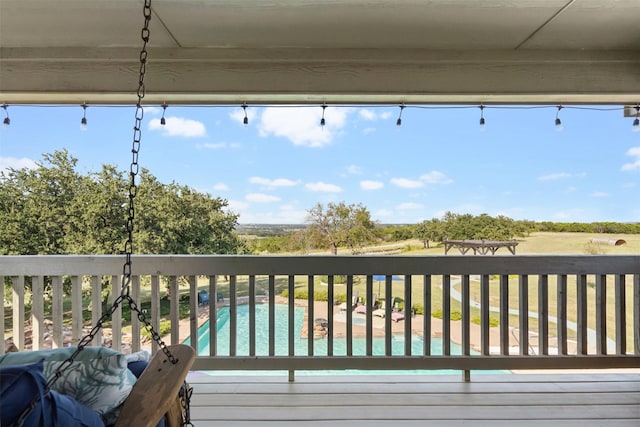 wooden deck with a community pool