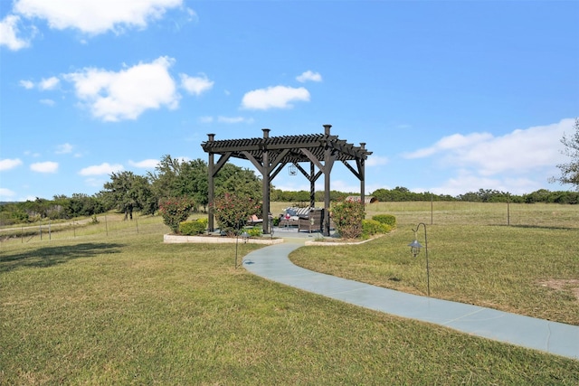 view of community with a yard and a pergola