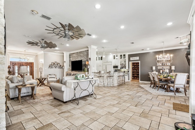 living room featuring crown molding and ceiling fan with notable chandelier