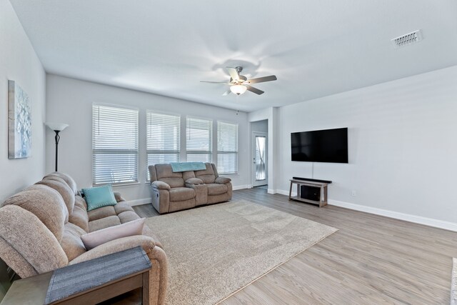 living room with ceiling fan and hardwood / wood-style flooring