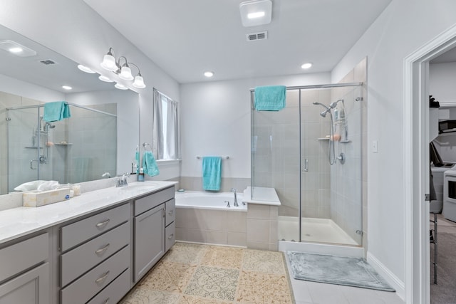 bathroom featuring separate shower and tub and vanity