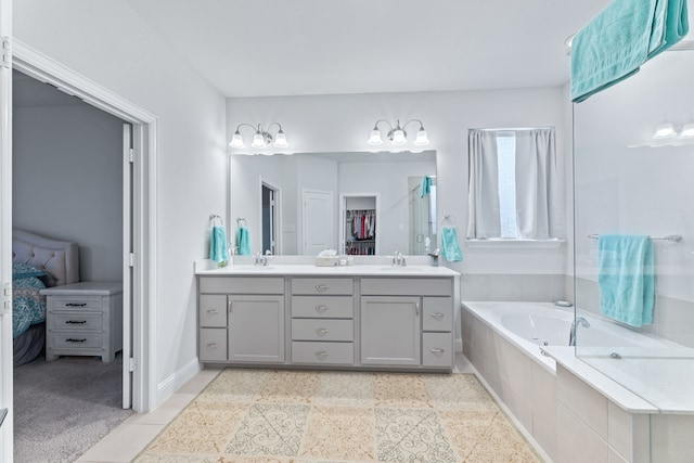 bathroom featuring vanity and tiled bath