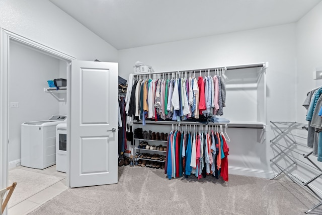 walk in closet with washer and clothes dryer and carpet