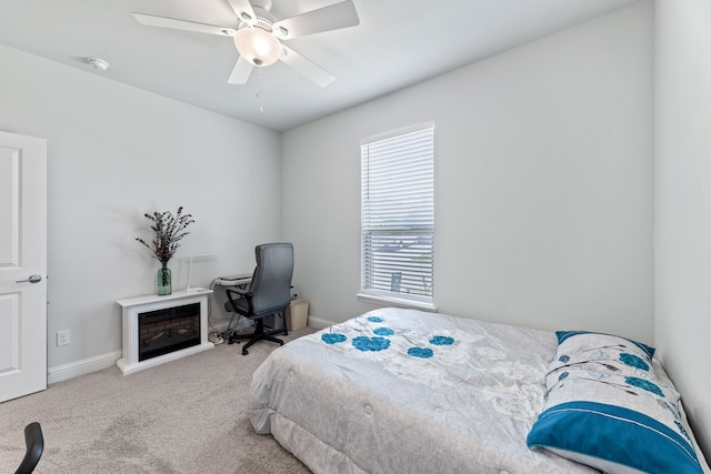 bedroom with ceiling fan and light carpet