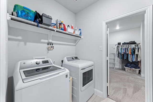 laundry area featuring light carpet and independent washer and dryer