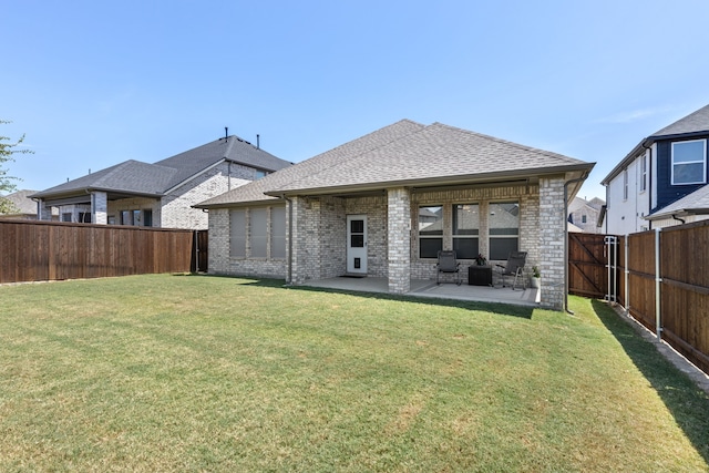 rear view of property featuring a patio and a lawn