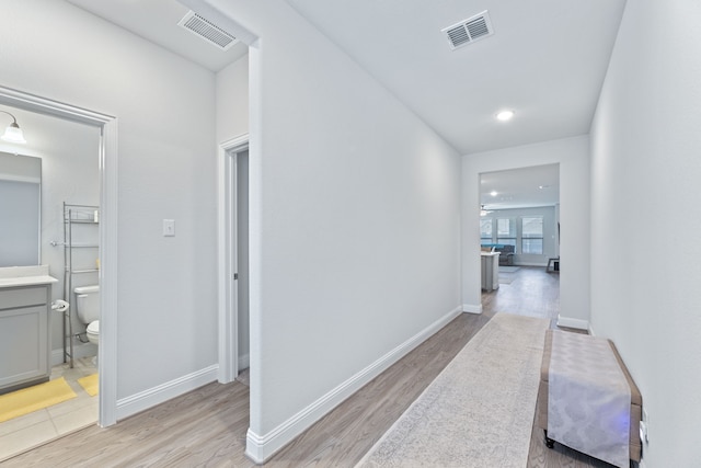 corridor featuring light hardwood / wood-style floors