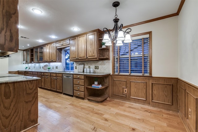 kitchen featuring stainless steel dishwasher, crown molding, decorative light fixtures, a notable chandelier, and light hardwood / wood-style floors