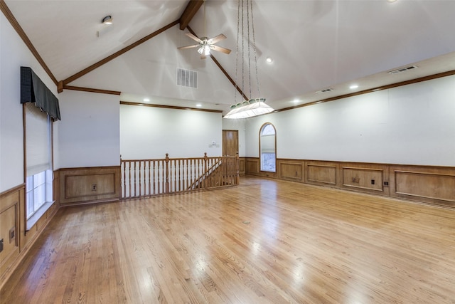 unfurnished room with light hardwood / wood-style floors, crown molding, beam ceiling, and high vaulted ceiling