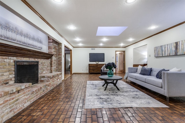 living room featuring a fireplace, a skylight, and ornamental molding