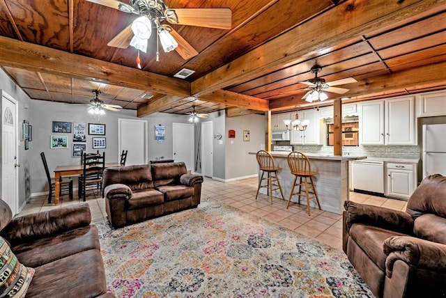 326 Glomin Ln, Pottsboro, TX 75076 - living room with light tile patterned floors, baseboards, ceiling fan, wood ceiling with exposed beams, and a chandelier