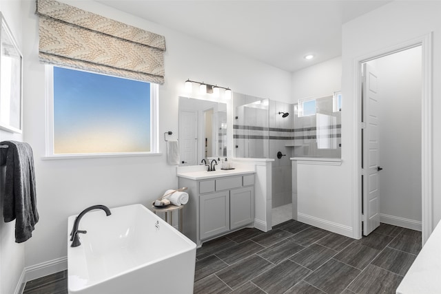 bathroom featuring a wealth of natural light, vanity, and shower with separate bathtub