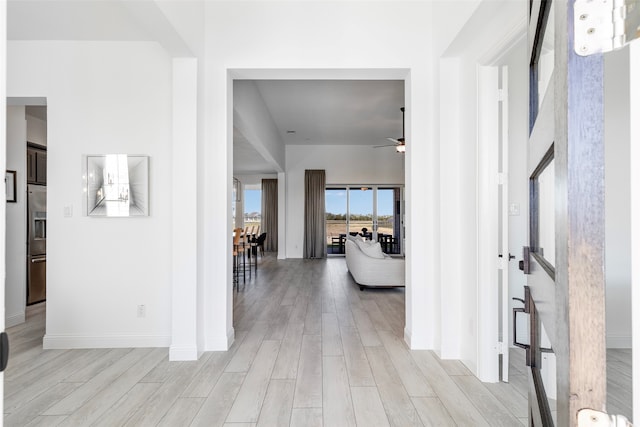 hallway with light hardwood / wood-style flooring