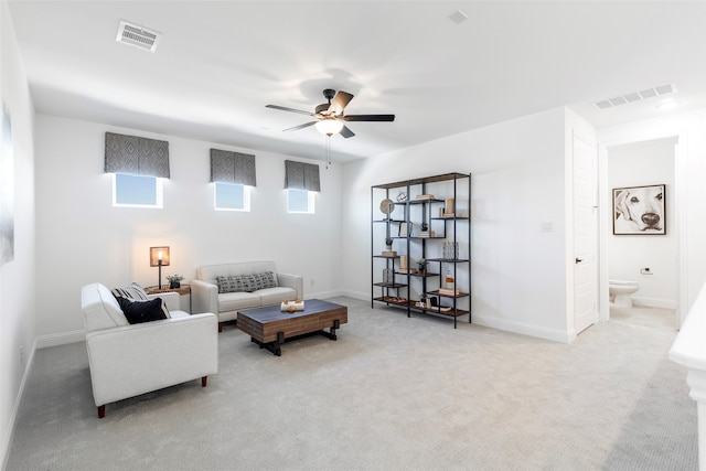 living room featuring carpet flooring and ceiling fan