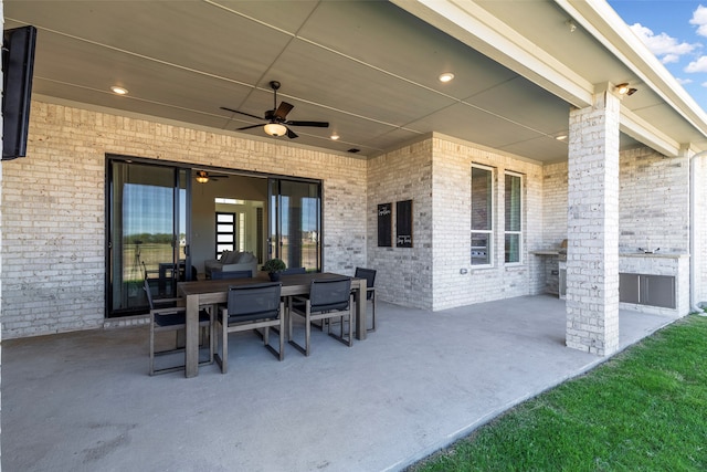 view of patio featuring a fireplace and ceiling fan