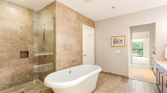 bathroom featuring vanity and independent shower and bath