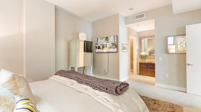 carpeted bedroom featuring connected bathroom