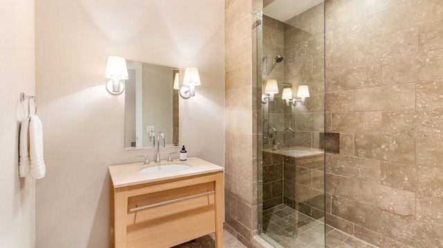 bathroom featuring vanity and tiled shower