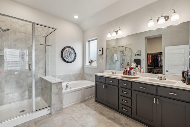 bathroom featuring tile patterned floors, vanity, independent shower and bath, and lofted ceiling