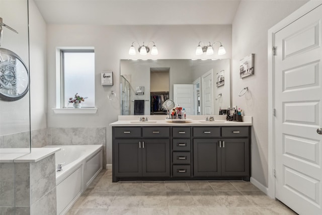 bathroom featuring tile patterned floors, a bathing tub, and vanity